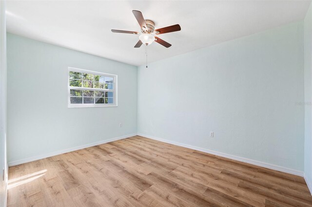 1119 77th St N, Saint Petersburg, FL 33710 - unfurnished room with baseboards, a ceiling fan, and wood finished floors