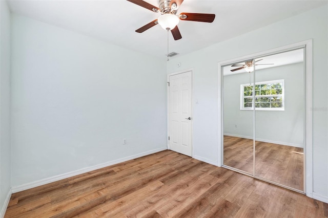 1119 77th St N, Saint Petersburg, FL 33710 - unfurnished bedroom featuring visible vents, baseboards, wood finished floors, a closet, and a ceiling fan
