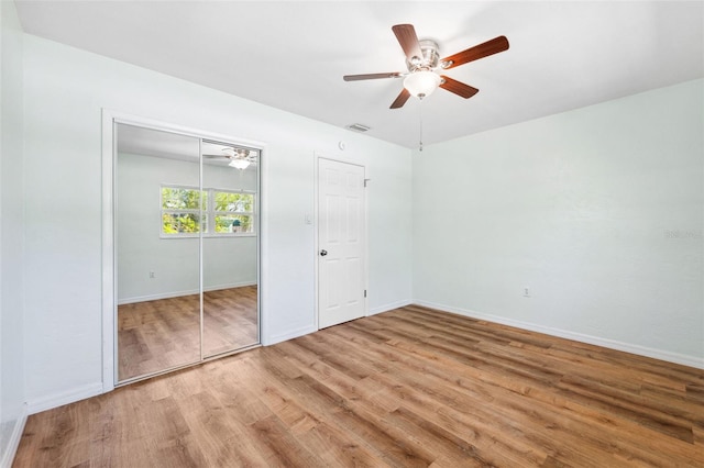 1119 77th St N, Saint Petersburg, FL 33710 - unfurnished bedroom with wood finished floors, visible vents, baseboards, ceiling fan, and a closet