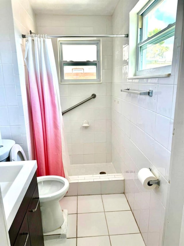 bathroom featuring walk in shower, a healthy amount of sunlight, tile patterned floors, and tile walls