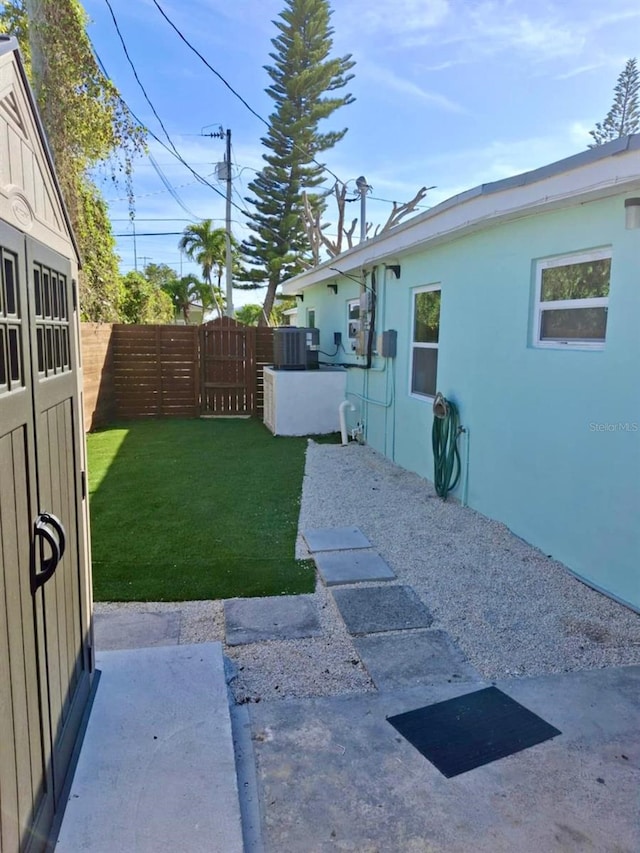 view of yard with cooling unit and a patio area