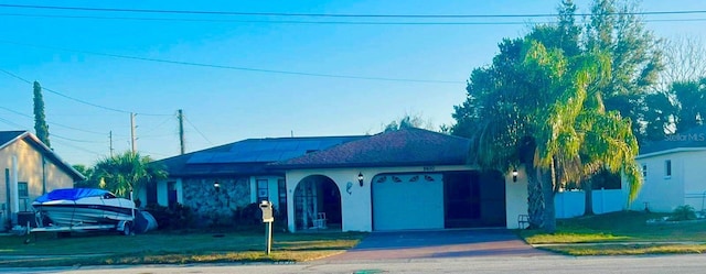 view of front of house featuring a garage and a front lawn