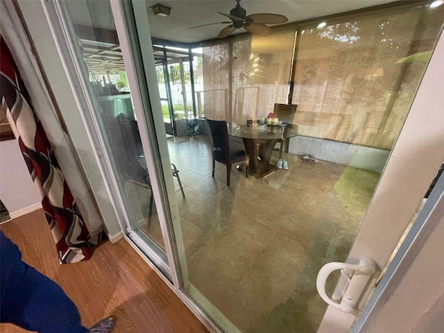 bathroom with hardwood / wood-style flooring and ceiling fan