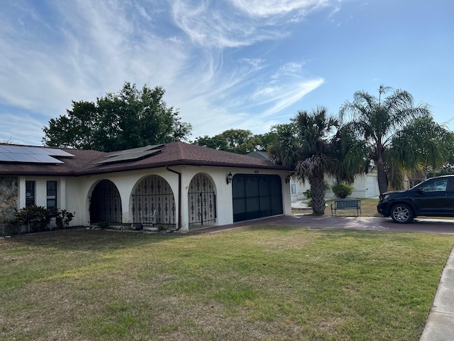 8630 Winter Haven Dr, Hudson, FL 34667 - view of side of home featuring solar panels, a lawn, driveway, an attached garage, and stucco siding