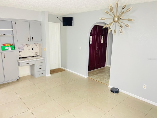 8630 Winter Haven Dr, Hudson, FL 34667 - foyer featuring arched walkways, a textured ceiling, and baseboards