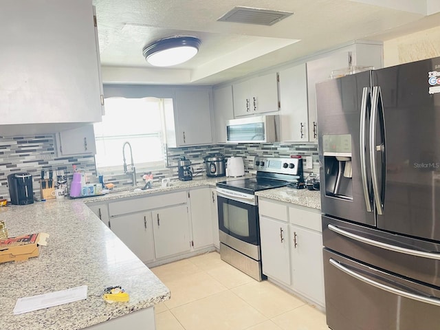 8630 Winter Haven Dr, Hudson, FL 34667 - kitchen featuring appliances with stainless steel finishes, light countertops, backsplash, and a sink