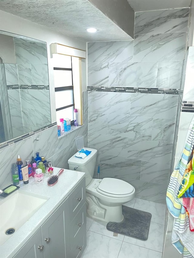 8630 Winter Haven Dr, Hudson, FL 34667 - bathroom featuring marble finish floors, vanity, toilet, tile walls, and a shower
