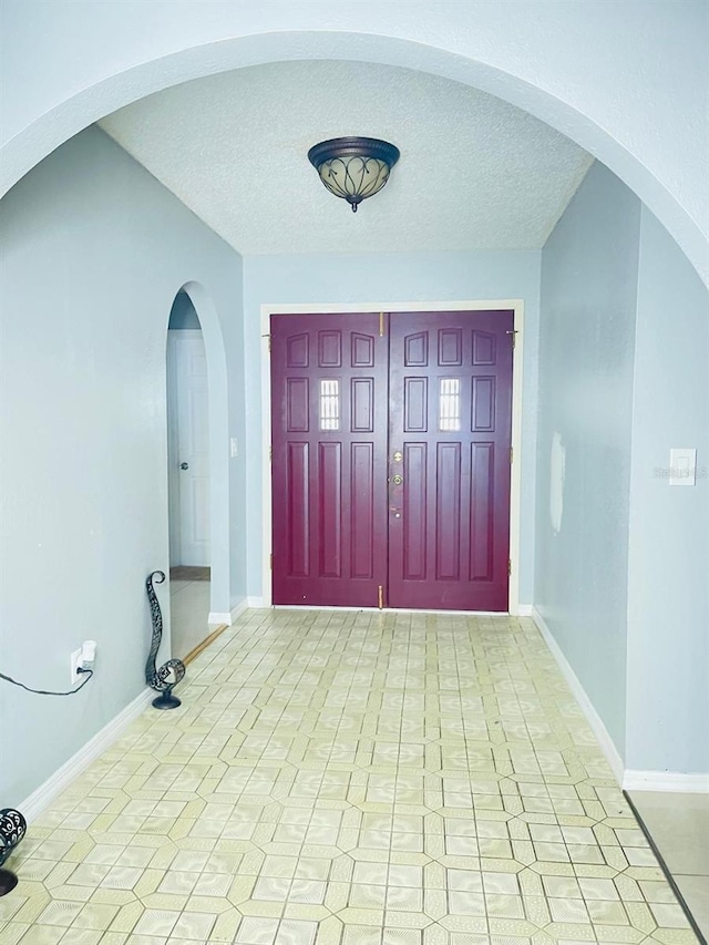 8630 Winter Haven Dr, Hudson, FL 34667 - entryway featuring baseboards and a textured ceiling