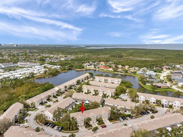 drone / aerial view featuring a water view and a residential view