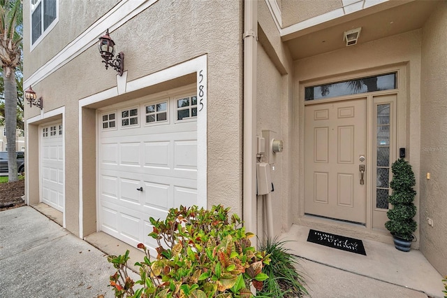 property entrance featuring stucco siding