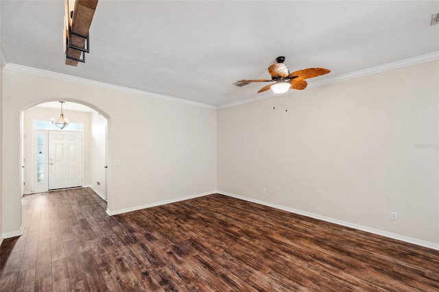 empty room featuring ornamental molding, arched walkways, baseboards, ceiling fan, and dark wood-style flooring