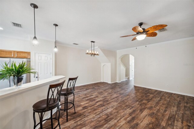 kitchen with visible vents, ceiling fan, dark wood finished floors, arched walkways, and refrigerator