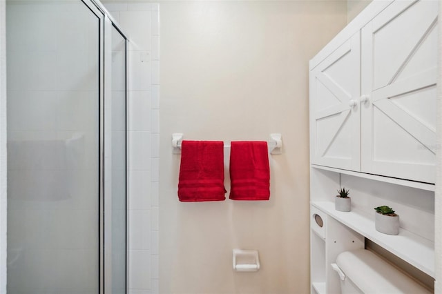 bathroom with toilet and a stall shower