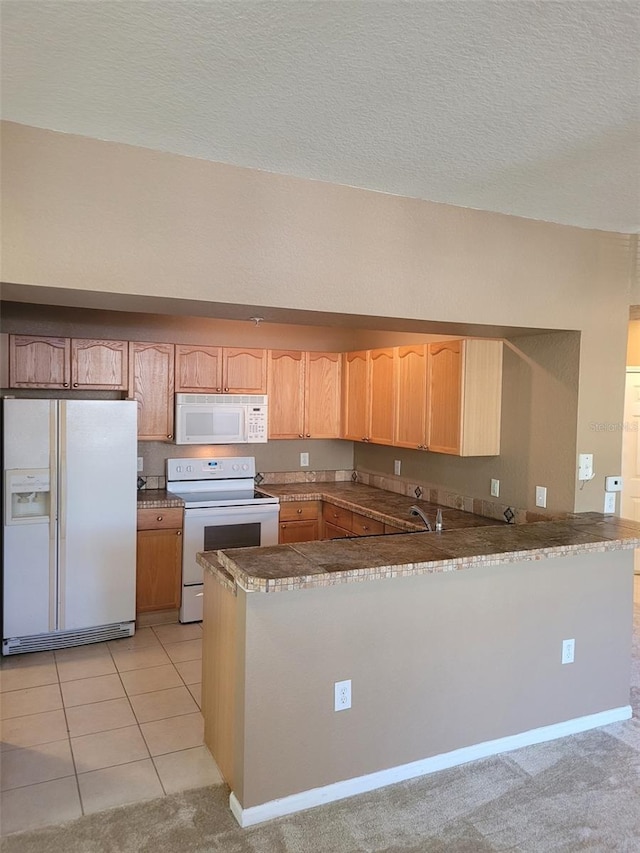 kitchen featuring light tile patterned flooring, white appliances, kitchen peninsula, and a textured ceiling