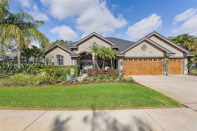 single story home with an attached garage, a front lawn, concrete driveway, and stucco siding