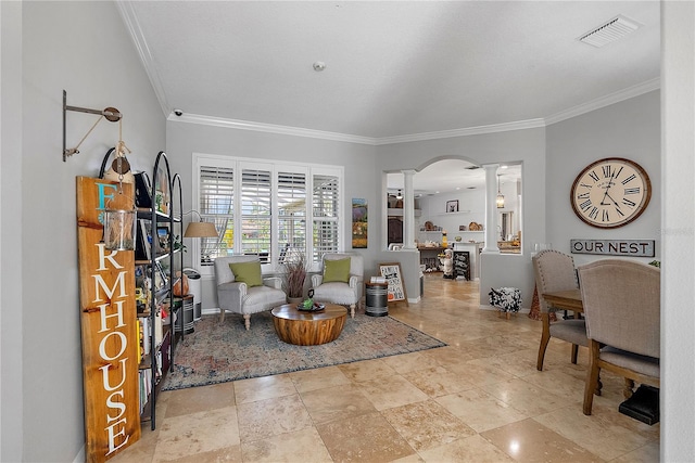 sitting room featuring decorative columns, visible vents, arched walkways, and crown molding