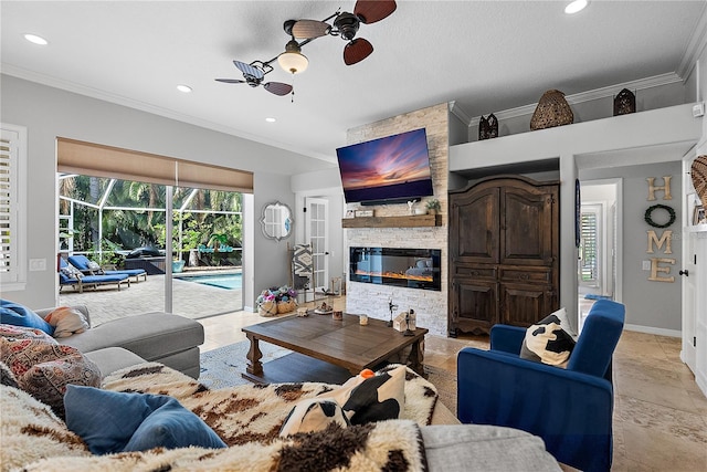 living room with crown molding, plenty of natural light, a fireplace, and ceiling fan