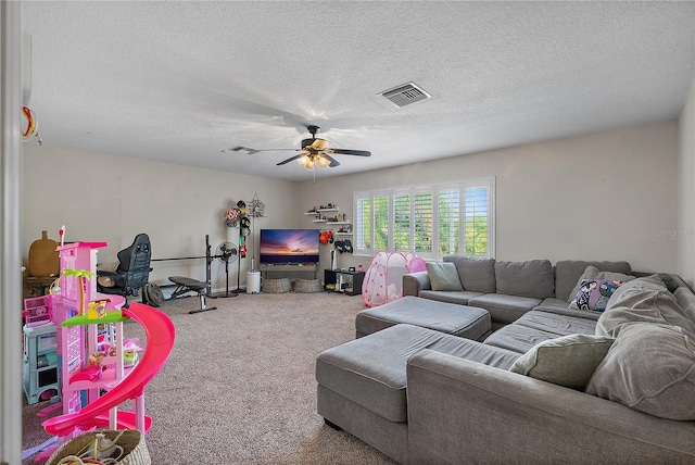 carpeted living area featuring a textured ceiling, ceiling fan, and visible vents