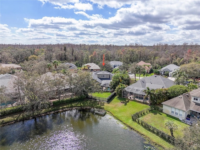 birds eye view of property featuring a residential view, a water view, and a wooded view