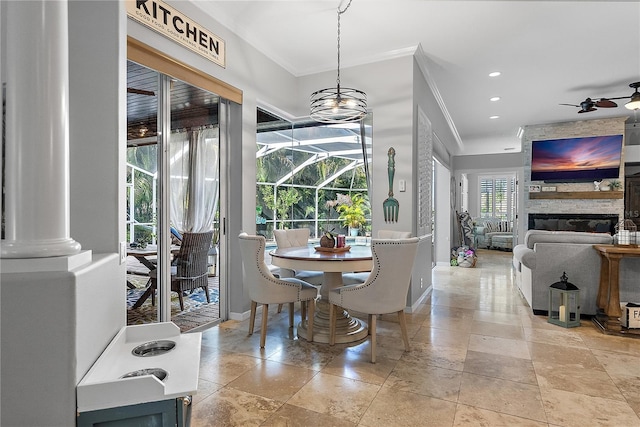 dining room featuring ceiling fan, recessed lighting, a fireplace, baseboards, and crown molding