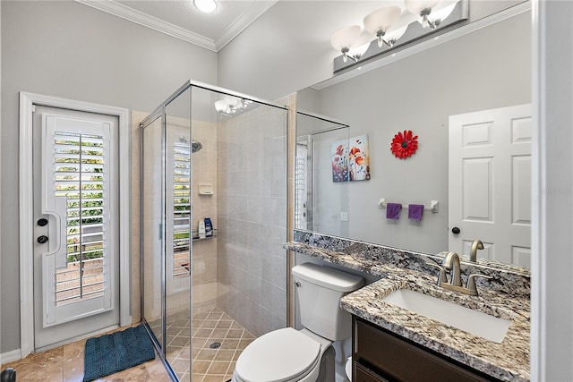 bathroom with toilet, a shower stall, crown molding, and vanity