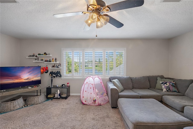 carpeted living area with ceiling fan, baseboards, and a textured ceiling