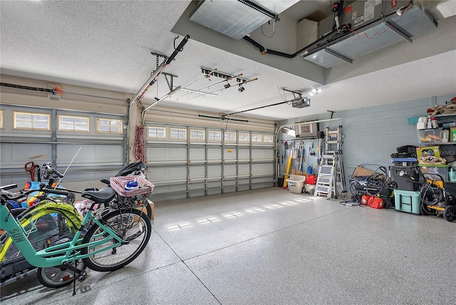 garage with concrete block wall and a garage door opener