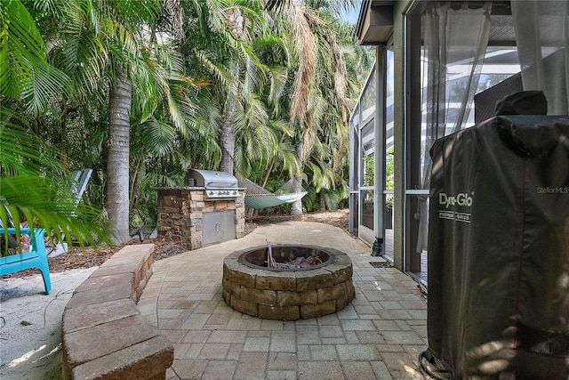 view of patio / terrace featuring an outdoor kitchen, a fire pit, and grilling area