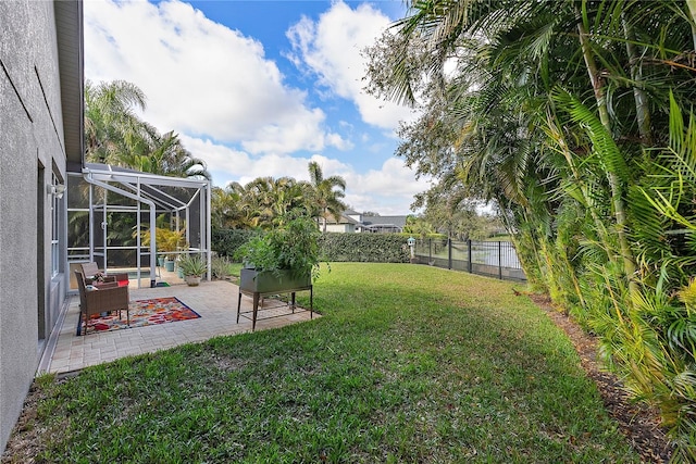 view of yard featuring a lanai, a patio area, and a fenced backyard