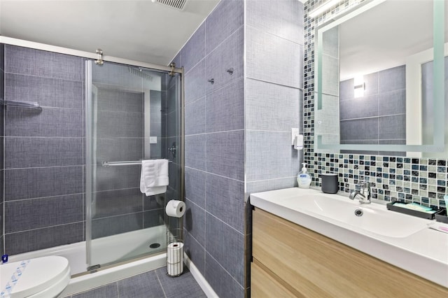 bathroom featuring toilet, tile walls, an enclosed shower, backsplash, and vanity