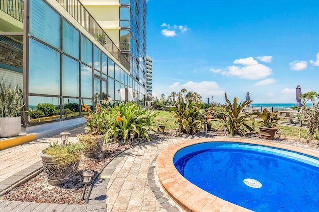 view of swimming pool featuring a water view