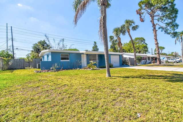 single story home featuring driveway, an attached garage, fence, and a front yard