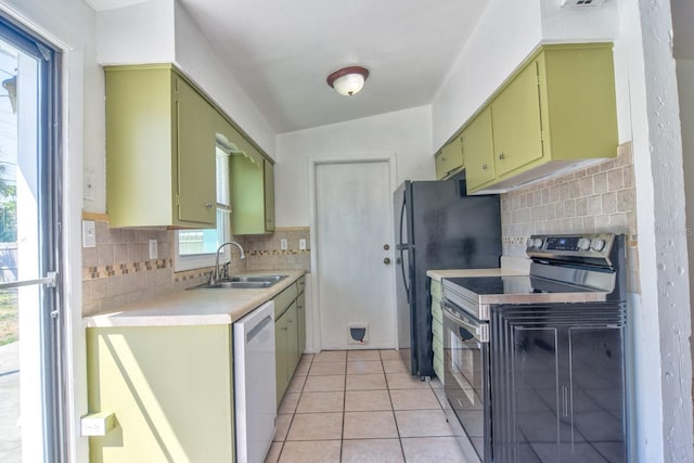 kitchen with a sink, dishwasher, green cabinetry, and electric stove