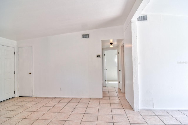 spare room featuring visible vents and light tile patterned floors