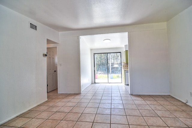 empty room with light tile patterned flooring and visible vents