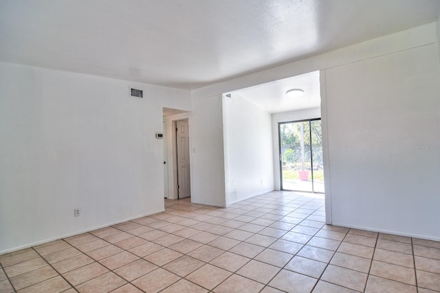 spare room with visible vents and light tile patterned flooring