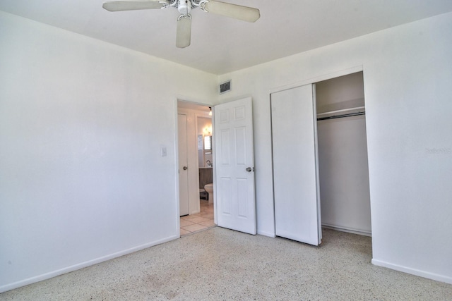 unfurnished bedroom featuring a closet, visible vents, baseboards, and speckled floor