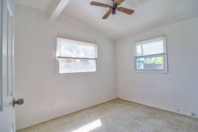 spare room with ceiling fan, vaulted ceiling with beams, and speckled floor