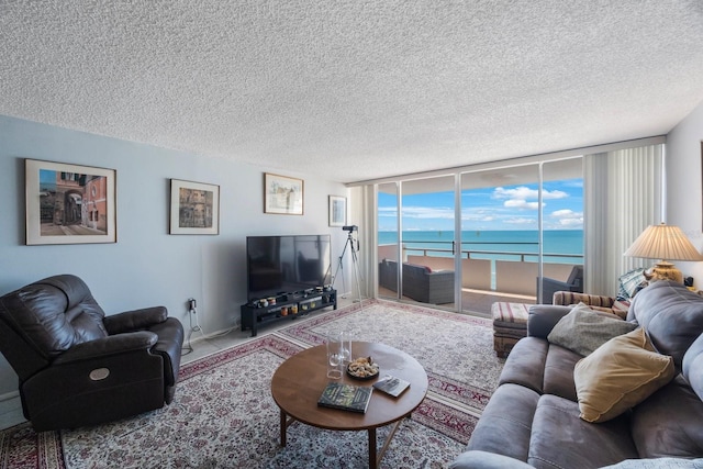 living room with expansive windows and a textured ceiling