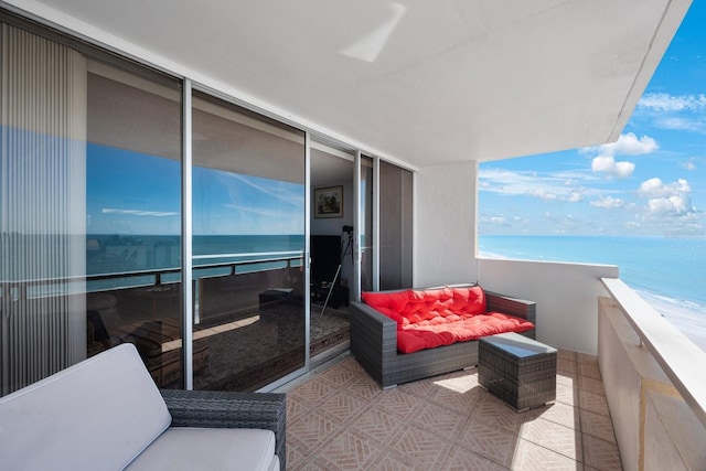 balcony featuring a water view and a view of the beach