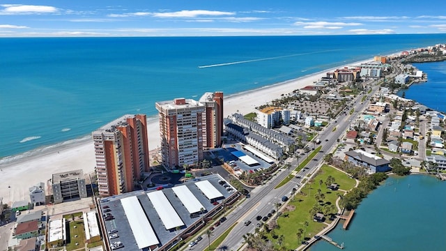 birds eye view of property featuring a view of city, a water view, and a beach view