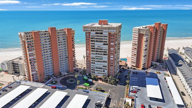 aerial view with a view of the beach, a water view, and a city view