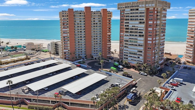 aerial view featuring a view of city, a beach view, and a water view