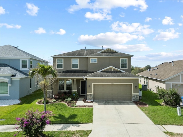 view of front of property featuring driveway, a front yard, and stucco siding