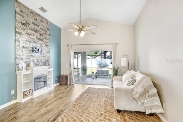 living room featuring ceiling fan, high vaulted ceiling, and wood-type flooring