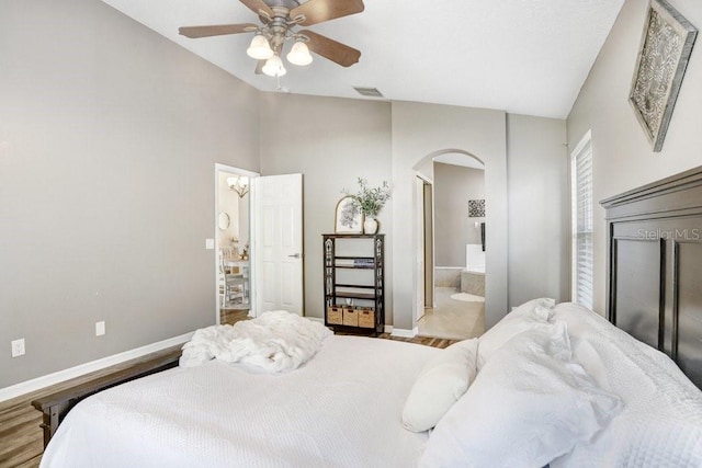 bedroom featuring light wood-type flooring, ensuite bathroom, and ceiling fan