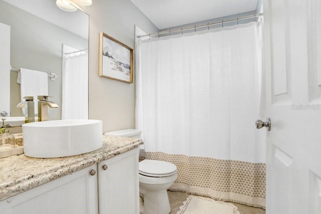 bathroom featuring toilet, tile patterned flooring, and vanity