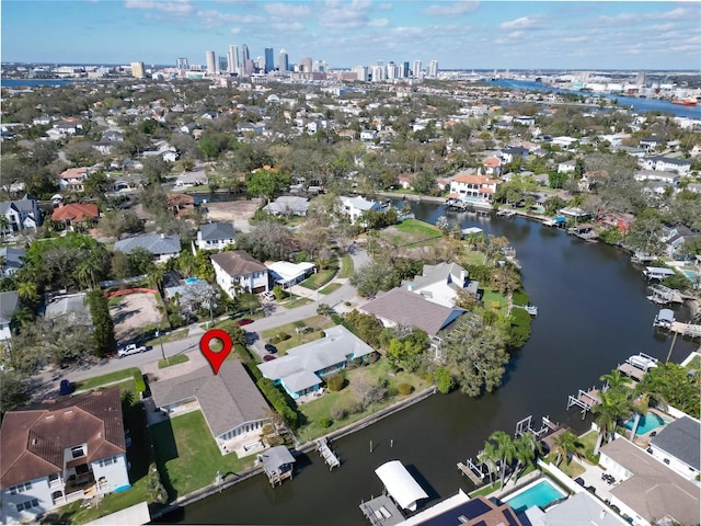 drone / aerial view with a water view, a residential view, and a city view