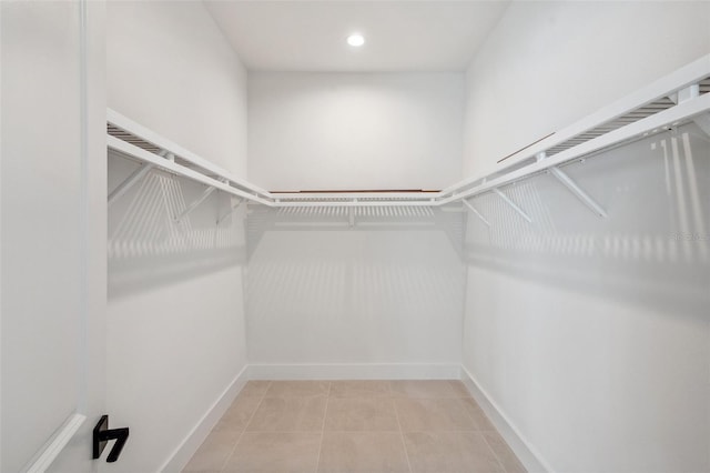 spacious closet featuring light tile patterned floors