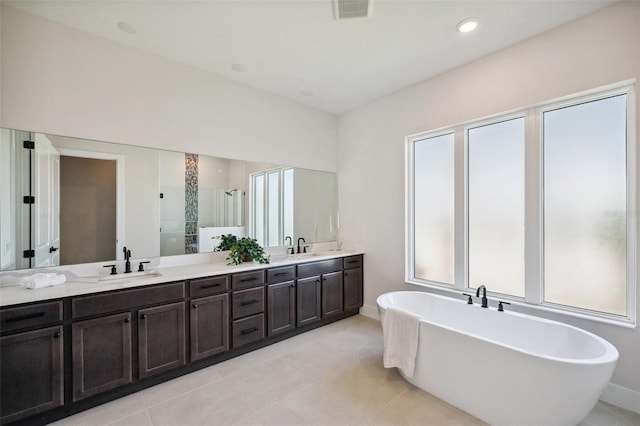 bathroom featuring vanity, shower with separate bathtub, and tile patterned flooring